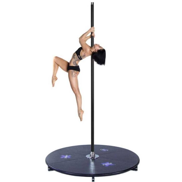 dancing on a black powder coated x stage lite portable freestanding dance pole with platform base