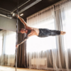 man on removalbe portable spinning static chrome 45mm dance pole in studio use dancing fitness