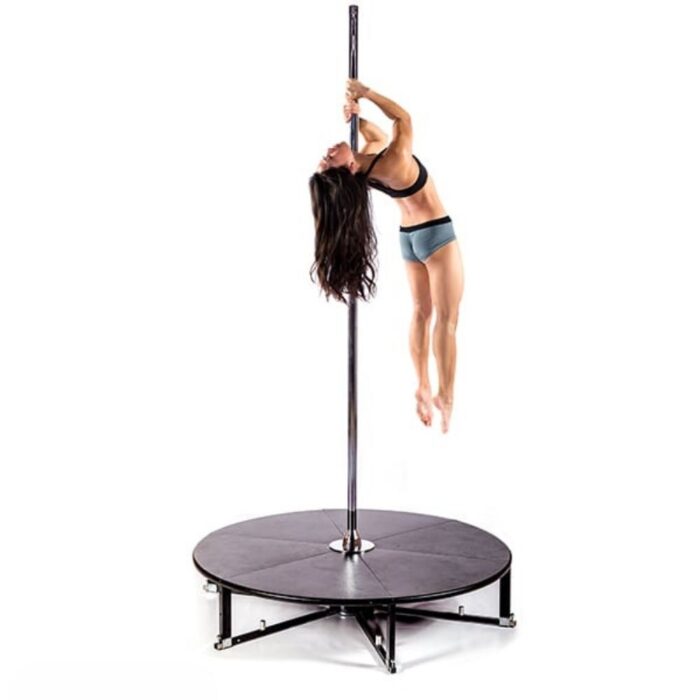 a woman practicing pole fitness dancing on an x stage standard