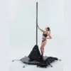 A female pole dancer is getting ready to use her free online pole dance lessons with Lupit freestanding portable stage base platform dance pole